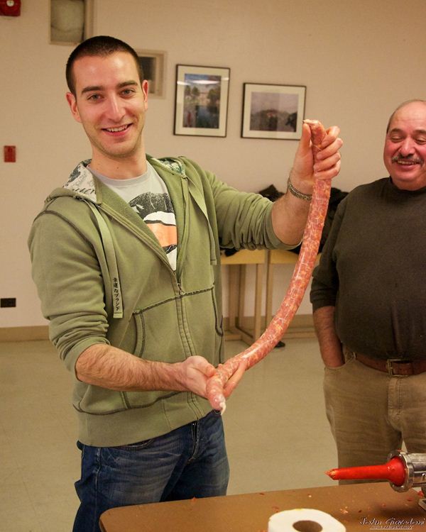 A man and Gennaro Pellagrino holding a long salciccia
